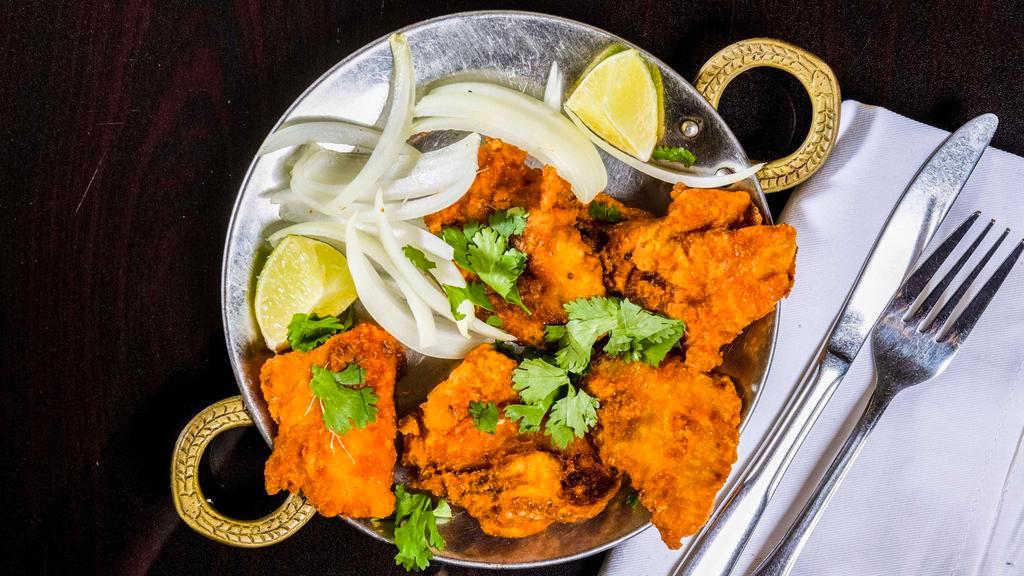 Fish Pakora · Fish marinated in spices and deep fried.