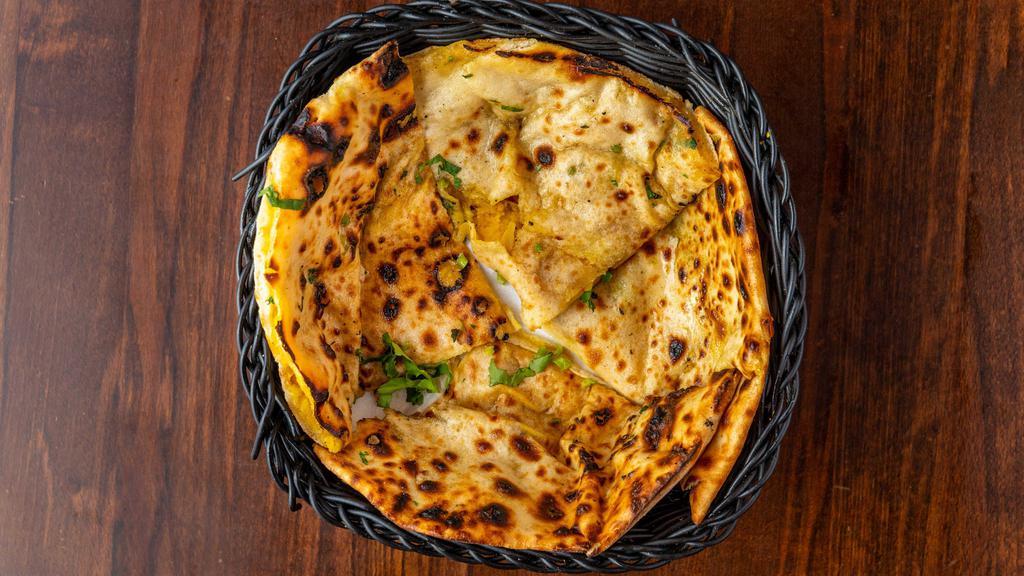 Aloo Paratha · Layered bread freshly made with butter stuffed potatoes.