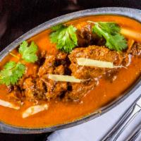 Goat Curry · Slow cooked very tender goat stew in a curry and spices.