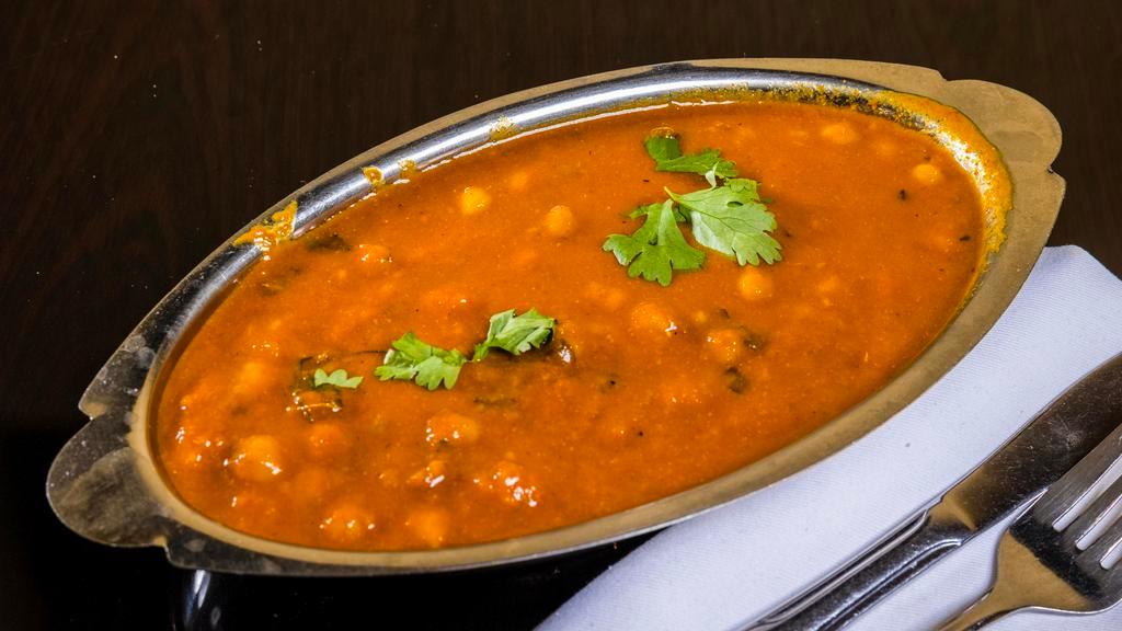 Chana Masala  · Chick peas cooked in onion, tomato ginger and garlic with spices.