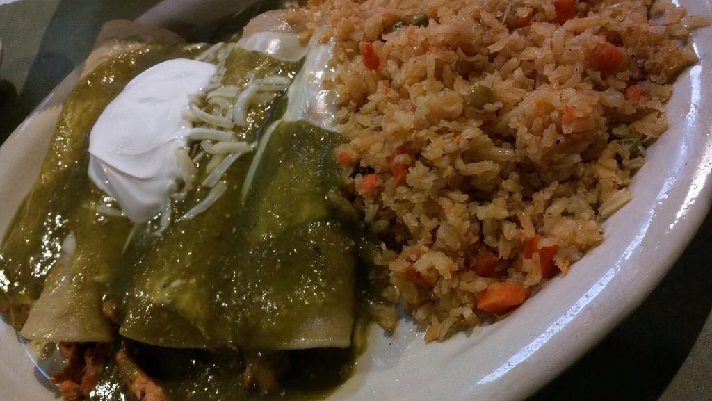 Enchilada Suizas · Three fresh corn tortillas filled with marinated chicken breast and smothered with cheese sauce and housemade tomatillo sauce and rice