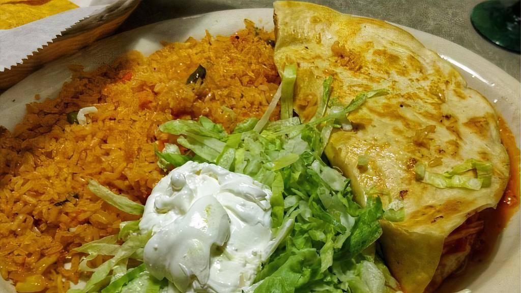 Quesadilla Rellena · You pick it - chicken or seasoned ground beef and we'll add cheese and beans. Served with rice, lettuce and sour cream.