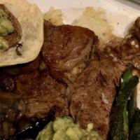 Carne Asada · A half pound thin cut steak, . Offered with refried beans, rice , lettuce, guacamole, pico d...