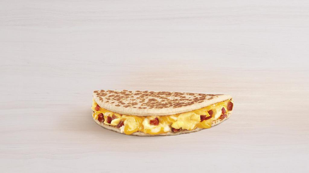 Breakfast Flatbread Melt Bacon · A pillowy flatbread filled with fluffy eggs, bacon, and melted three-cheese blend.