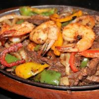 Fajitas (Lunch) · Your choice of protein with onions, tomatoes, bell peppers, lettuce, tomato, sour cream, gua...