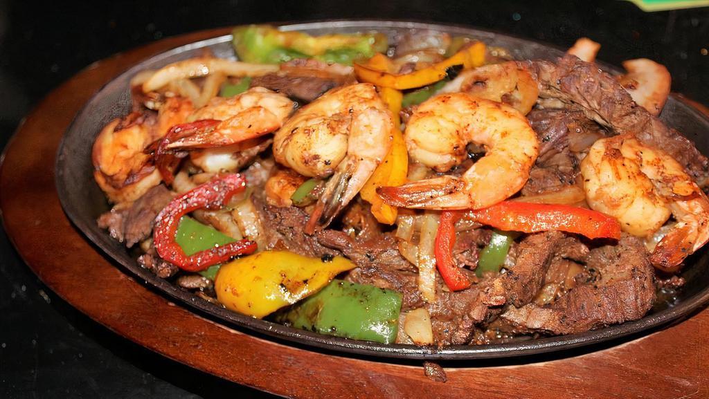 Fajitas · Your choice of protein, onions, tomatoes, and bell peppers. Served with lettuce, tomatoes, sour cream, guacamole, tortillas, rice, and your choice of charro or refried beans.