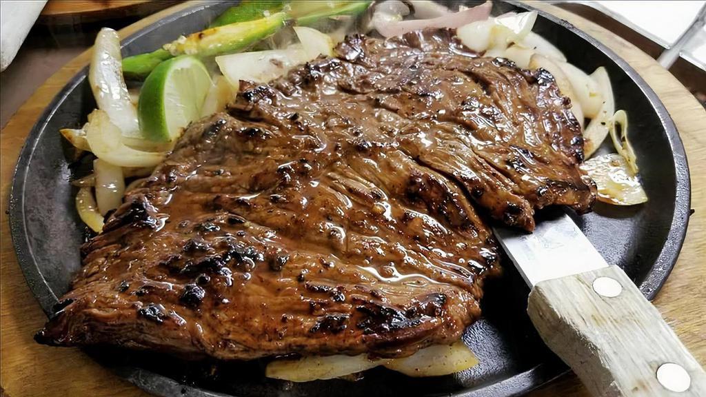 Carne Asada · Served with rice. Your choice of charro or refried beans, flour tortillas, and an avocado salad.
