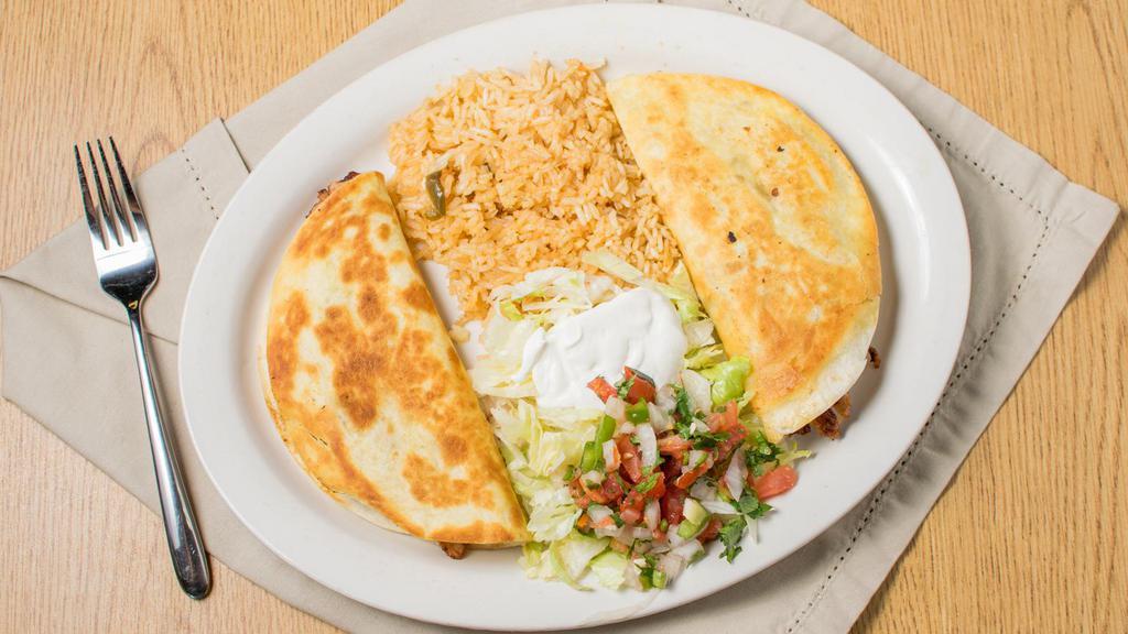 Quesadilla Ranchera · Two flour tortillas stuffed with grill chicken or steak , cheese, grilled to golden crispiness and served with lettuce, sour cream, pico de gallo, and rice.you can order with schimp 9.99