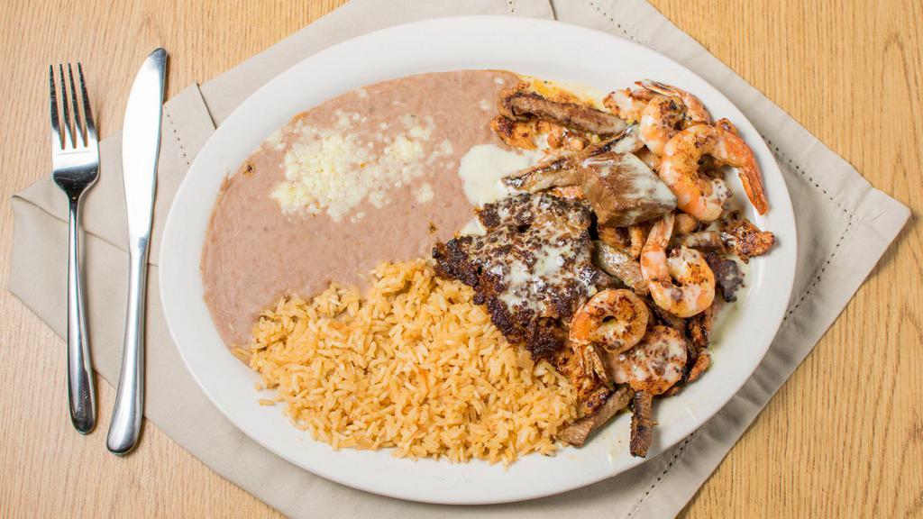 Cazuelon · Flour or corn tortillas, served with rice, beans with chicken, steak, shrimp, chorizo, and carnitas covered with cheese sauce.