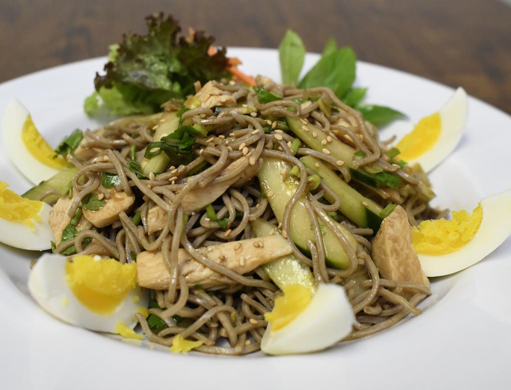 Sesame Soba · Japanese cold soba noodles in sesame soy dressing with cilantro, scallions, sesame seeds, boiled egg, cucumber, and chicken.