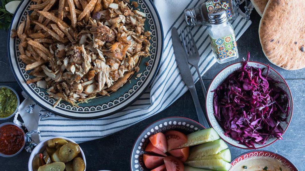 Chicken Shawarma Family Meal · Serves 4 people. Includes:
- Chicken Shawarma
- 4 Pitas
- Hummus
- Fries
- Your choice of salads: Red Cabbage Salad, Cucumber Tomato salad, Onion Sumac
- Your choice of sauces: Garlic, Tahini, Amba