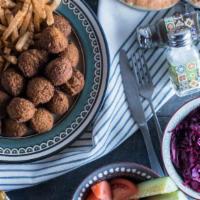 Falafel Family Meal · Serves 4 people. Includes:
- Falafel
- 4 Pitas
- Hummus
- Fries
- Your choice of salads: Red...