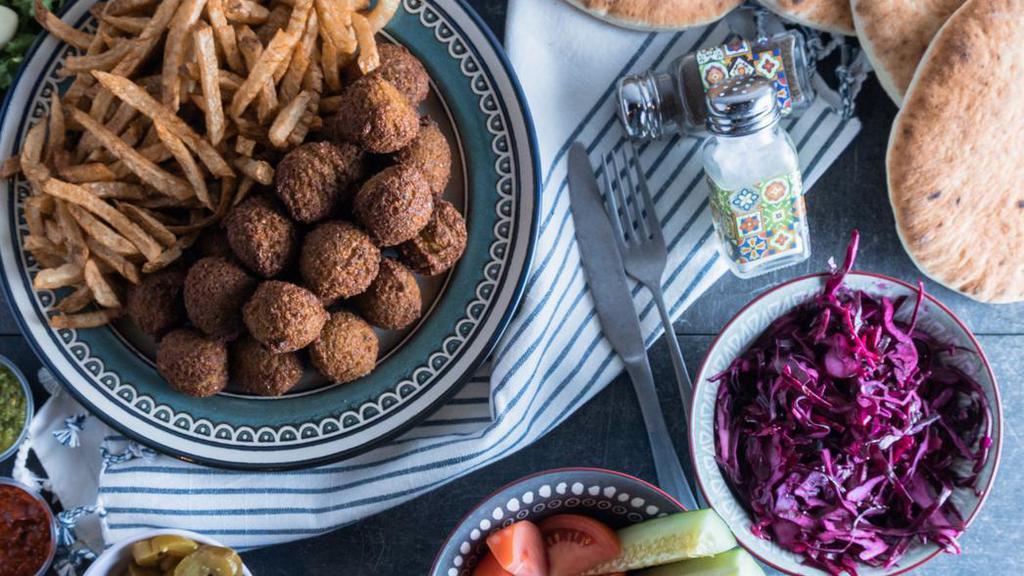 Falafel Family Meal · Serves 4 people. Includes:
- Falafel
- 4 Pitas
- Hummus
- Fries
- Your choice of salads: Red Cabbage Salad, Cucumber Tomato salad, Onion Sumac
- Your choice of sauces: Garlic, Tahini, Amba