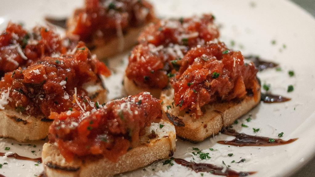 Traditional Bruschetta · Tomato, basil, and house-made ricotta served on crostini with a drizzle of balsamic reduction.