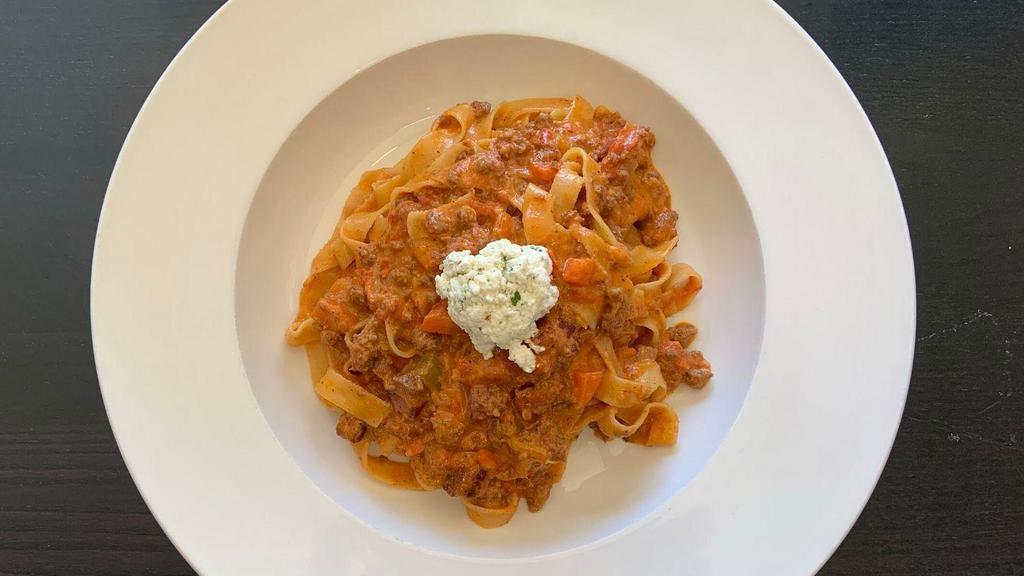 Tagliatelle Bolognese · Thinly sliced house-made tagliatelle with local beef and pancetta bolognese and house-made ricotta.