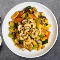 Cashew Chicken · Chicken sauteed with minced garlic, bell peppers, babay corn, carrots, onions, mushrooms, ba...