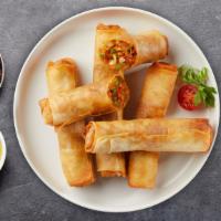 Vegetable Spring Roll · (2 pieces) Seasonal vegetables wrapped in rice wrapper and fried until golden crisp