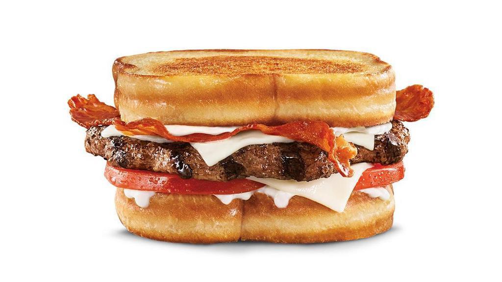 Frisco Angus Burger · Charbroiled Third Pound 100% black angus beef patty, crispy bacon, melted Swiss cheese, tomato, and mayonnaise, served on toasted sourdough.