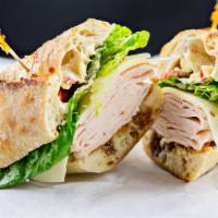 Turkey & Provolone · Layers of slow roasted turkey breast, provolone cheese, romaine lettuce, roasted tomatoes, m...
