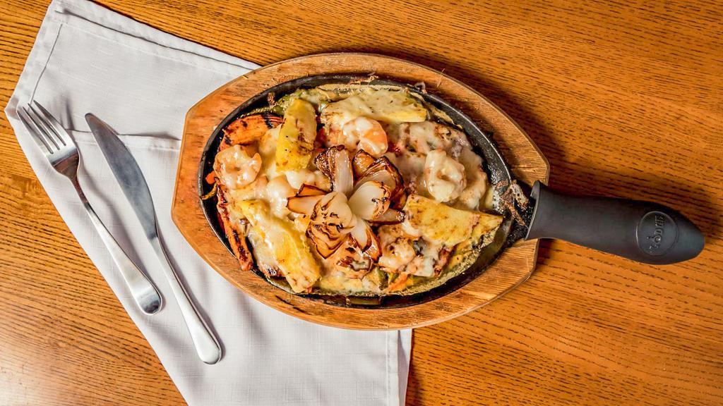 Pollo Tropical · Char-broiled chicken breast topped with shrimp peppers, pineapple and melted cheese and a special flower onion rice and beans.