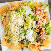 Nachos Grandes · Beef or chicken with lettuce, guacamole, sour cream, refried beans, shredded cheese and chop...
