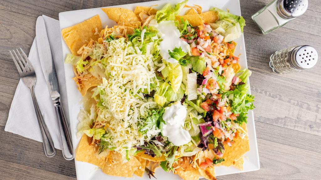 Nachos Grandes · Beef or chicken with lettuce, sour cream, refried beans, shredded cheese and pico de gallo.