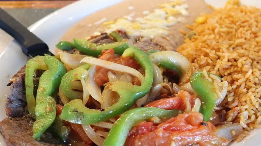 Steak Mexicano · T bone smothered with cooked onions, bell peppers, and tomatoes. Served with rice and choice of beans or French fries.