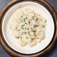 Tortellini Alfredo · Fresh tortellini pasta tossed in creamy white sauce topped aged parmesan.