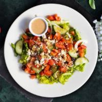 Greek Salad · Crumbled feta, black olives, sliced cucumber, tomatoes, red onions, green peppers tossed ove...