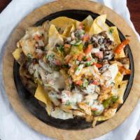 Nachos Fajita · Your choice of up to two grilled proteins sautéed with onions and bell peppers, topped with ...