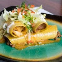 Enchiladas Supremas · Four enchiladas: one slow-cooked shredded chicken, one seasoned ground beef, one cheese, and...