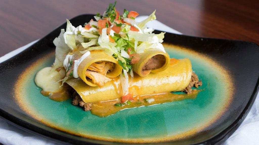 Enchiladas Supremas · Four enchiladas: one slow-cooked shredded chicken, one seasoned ground beef, one cheese, and one refried bean, hand rolled in com tortillas and smothered in Las Palmas' special enchilada sauce, shredded cheese, lettuce, pico de gallo, and sour cream.