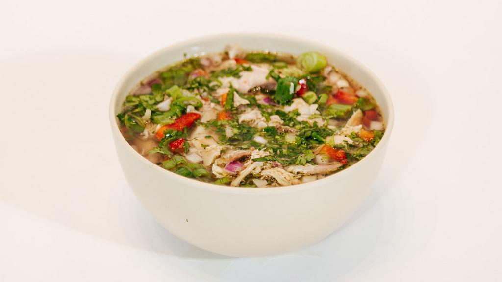 Sopa De Pollo · Pulled Rotisserie Chicken, Homemade Chicken Broth, Cilatro Infused Rice, Green Onions, Red Onions, Red Peppers, and Cilantro
