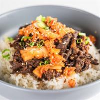 Bulgogi Bowl · Korean BBQ  beef on steamed white rice with homemade kimchi, cucumber and carrots.