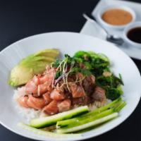 Salmon Poke · Fresh raw salmon tossed with sesame, onions, tamari, seaweed salad, and topped with avocado.