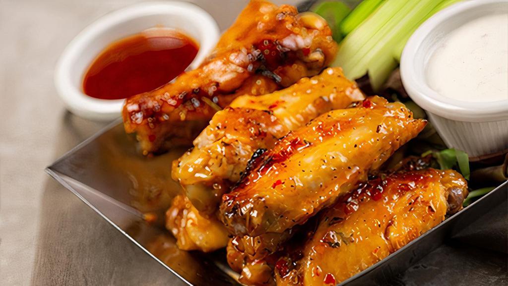 Sweet Thai Chili Wings · perfectly charred in our wood fired oven, then tossed in spicy-sweet chili sauce