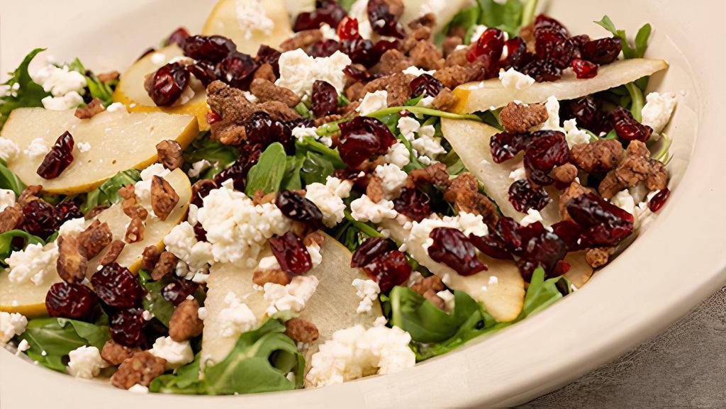 Arugula & Pear Salad · arugula topped with pears, candied pecans, gorgonzola and sun-dried cranberries with honey herb vinaigrette