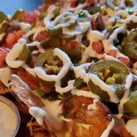 The South Of The Border · Our signature potato chips dusted with chili powder, pepper  jack cheese, pickled jalapenos,...