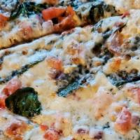 Caballo Blanco Pizza · Whole milk ricotta, garlic sauce, baby spinach, red onion, tomato, and mozzarella