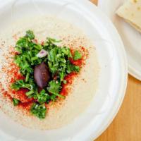 Hummus · Our homemade creamy chickpea mix with garlic, tahini, lemon, and olive oil. Served with pita.