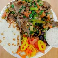 Gyro Shawarma · Mixed beef and lamb gyro cooked with onions, green pepper, tomatoes and. Tabbouleh served wi...