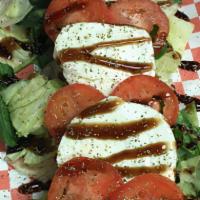 Caprese · Iceberg and Spinach Bed, Sliced Tomatoes, Roasted Red Peppers, Fresh Mozzarella, Balsamic Gl...