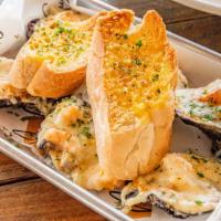Oysters Bread · Fried Oysters, cream spinach, bacon, provolone mozzarella, parmesan
cheese and chargrilled o...