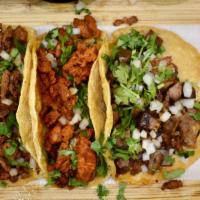 Tacos · Five and half inches pure corn tortilla, cilantro, onions. The meat of choice.