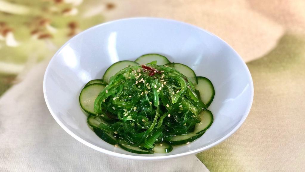 Seaweed Salad · Seaweed salad on a bed of english cucumbers with vinaigrette dressing.