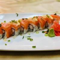 Alaska Roll · Crab, cucumber wrapped with salmon, thin slices of lemon and scallions.