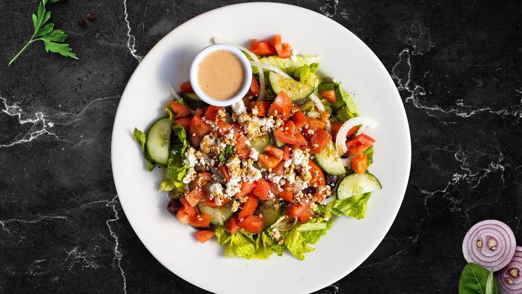 Greek Salad · Crumbled feta, black olives, sliced cucumber, tomatoes, red onions, green peppers tossed over crisp lettuce. Served with Greek Vinaigrette on the side.