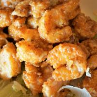 Firecracker Shrimp · A half pound of breaded, crispy fried shrimp tossed in our spicy cream sauce.  (Sauce is ser...