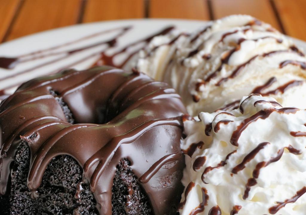 Hot Fudge Cake · A rich warm chocolate fudge cake served with whipped cream and vanilla bean ice cream.