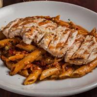 Chicken Pomodoro · Grilled chicken breast served over penne pasta and our creamy marinara sauce, sundried tomat...